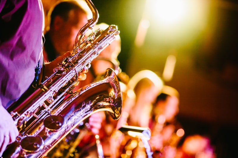 A saxophonist playing in a dimly lit venue